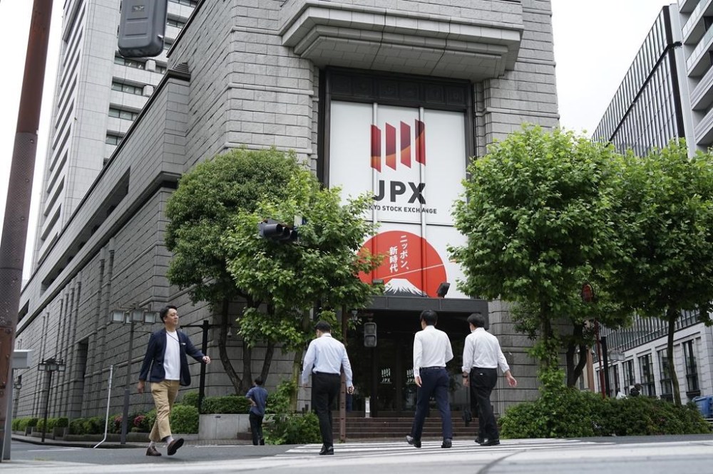 People walk in front of Tokyo Stock Exchange building Tuesday, May 28, 2024, in Tokyo. (AP Photo/Eugene Hoshiko)