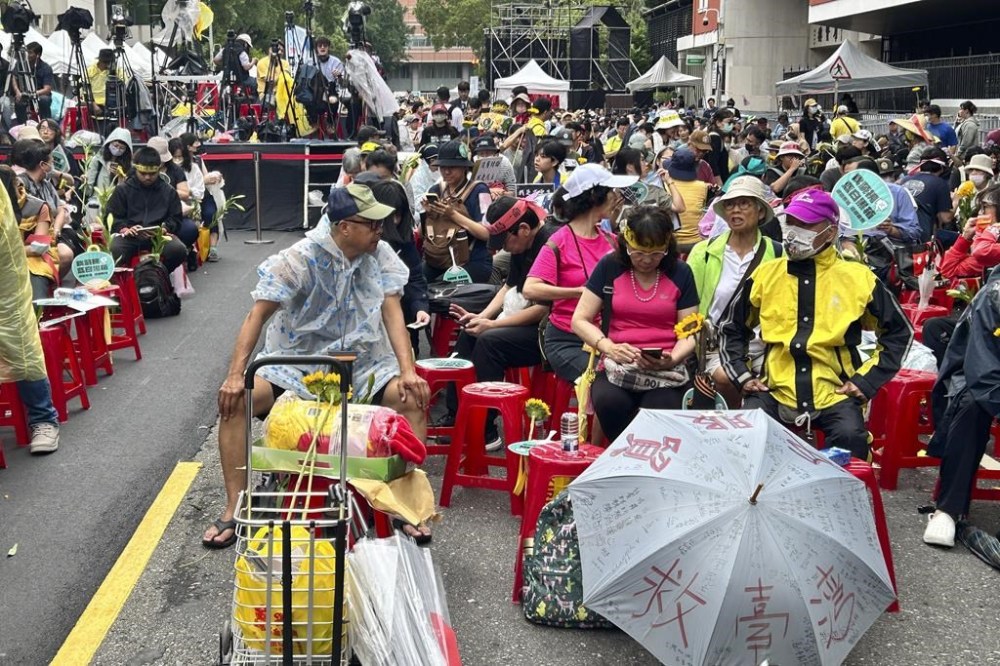 Protesters against controversial bills that aim to expand parliament's oversight of government gather outside the Parliament in Taipei, Taiwan on Tuesday, May 28, 2024. Taiwan's Parliament resumed sessions on Tuesday to discuss and vote on a set of bills that includes controversial legislation that aims to expand Parliament's oversight of the government. (AP Photo/Taijing Wu)