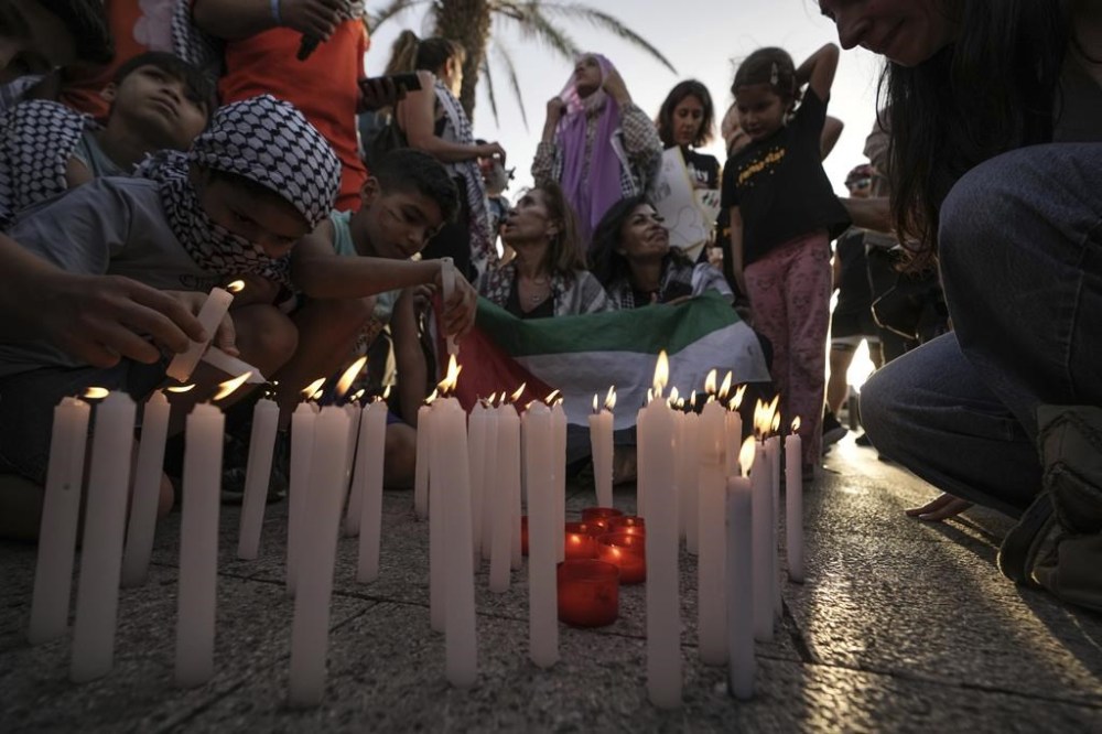 Children light candles during a march against Israel and in solidarity with Palestinians in the southern Gaza city of Rafah, on the Mediterranean Sea corniche in Beirut, Lebanon, Monday, May 27, 2024. Israeli Prime Minister Benjamin Netanyahu acknowledged Monday that a