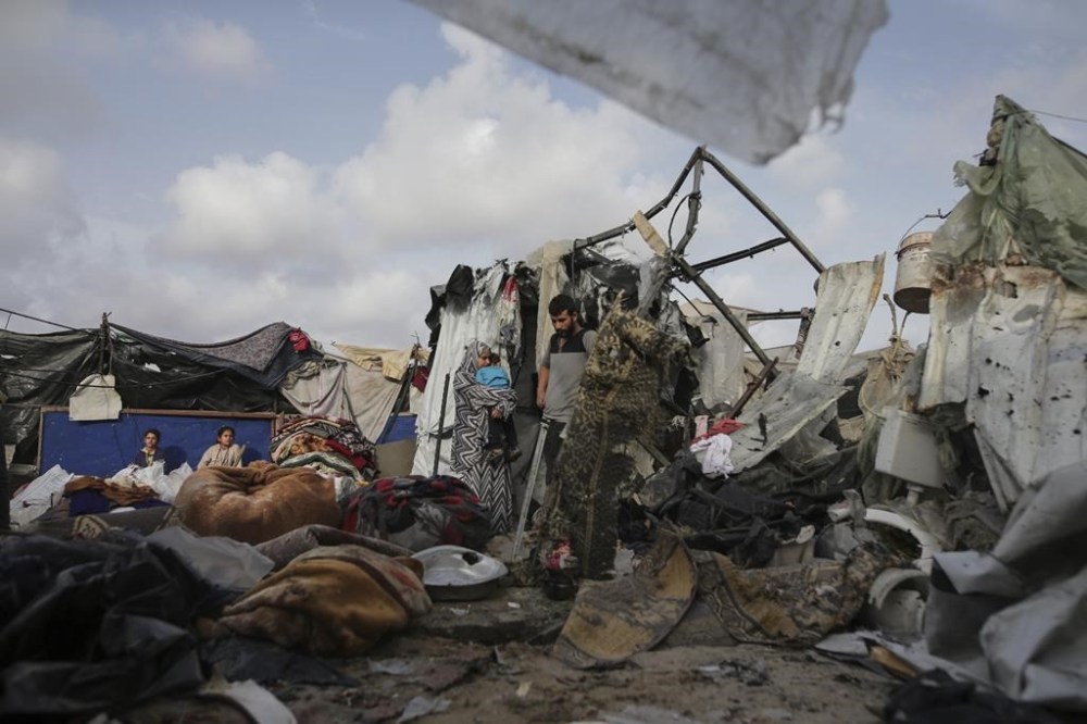 Displaced Palestinians inspect their tents destroyed by Israel's bombardment, adjunct to an UNRWA facility west of Rafah city, Gaza Strip, Tuesday, May 28, 2024. (AP Photo/Jehad Alshrafi)