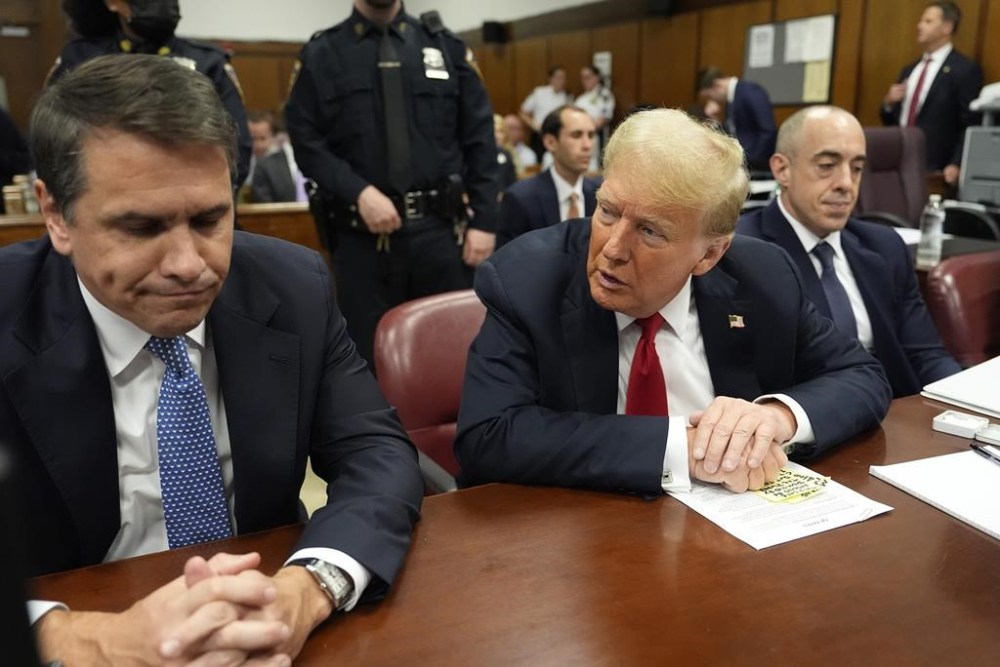 Former President Donald Trump speaks to his attorney Todd Blanche before the start of proceedings in Manhattan Criminal Court, Tuesday, May 28, 2024, in New York. (AP Photo/Julia Nikhinson, Pool)