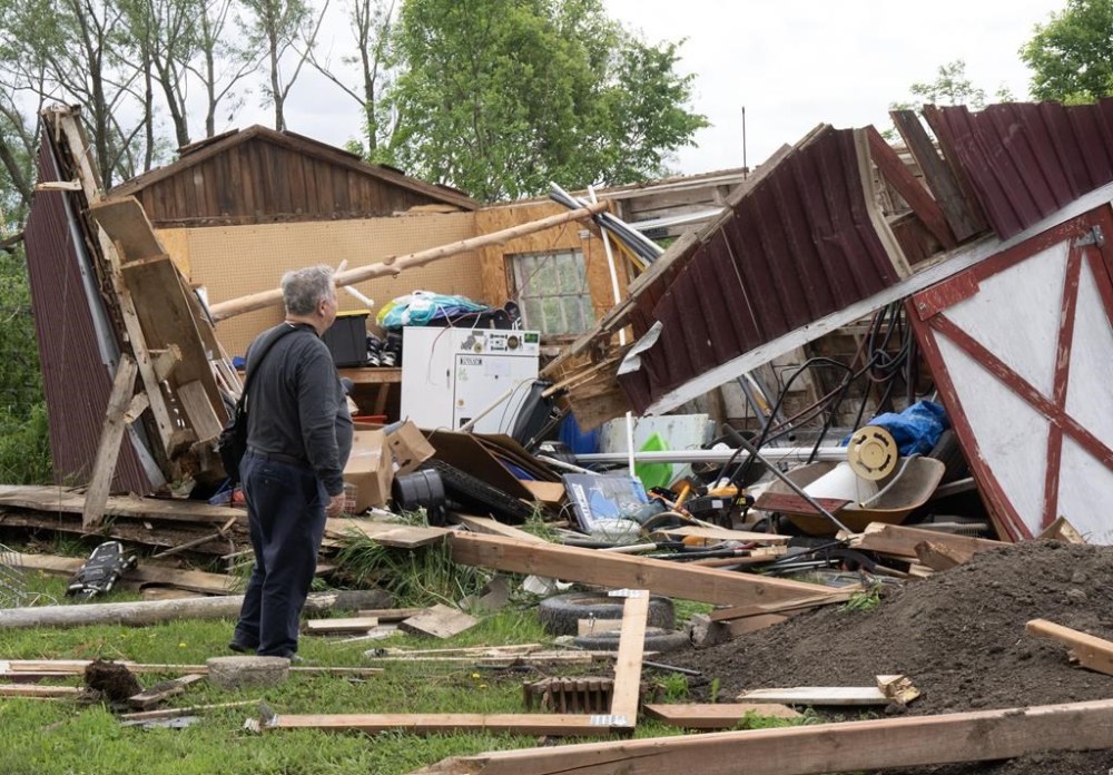 A man looks at the damage in Très-Saint-Rédempteur, Que., on Tuesday, May 28, 2024 after a tornado went through the prior evening.THE CANADIAN PRESS/Ryan Remiorz