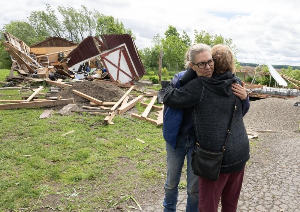 Julia Asselstine, left, gets a hug from a friend as they survey the damage to her property on Tuesday, May 28, 2024. in Tres-Saint-Redempteur, Que., after a tornado moved through Monday evening. THE CANADIAN PRESS/Ryan Remiorz