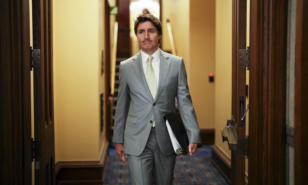 Prime Minister Justin Trudeau makes his way to talk to reporters in the foyer of the House of Commons on Parliament Hill in Ottawa on Tuesday, May 28, 2024. Trudeau says Canada does not at all support Israel's military offensive in the town of Rafah, but will not say whether he'll respond with any actions. THE CANADIAN PRESS/Sean Kilpatrick