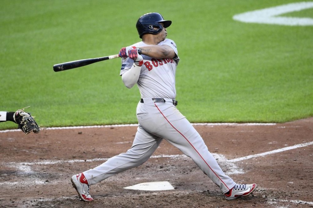Boston Red Sox's Rafael Devers follows through on his single during the fifth inning of a baseball game against the Baltimore Orioles, Tuesday, May 28, 2024, in Baltimore. (AP Photo/Nick Wass)