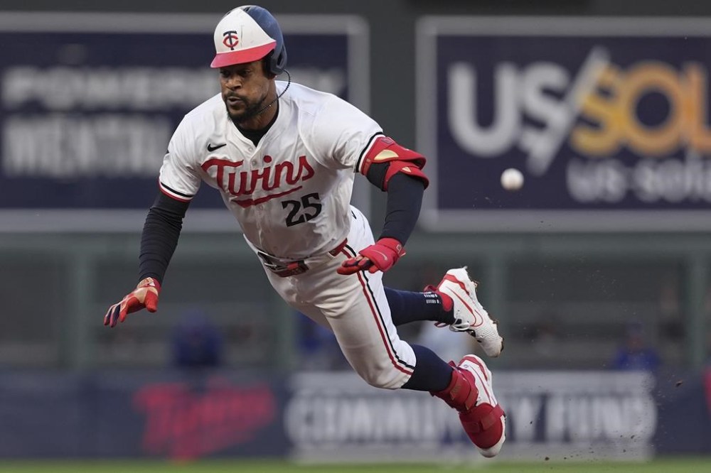 Minnesota Twins' Byron Buxton (25) dives into third base after hitting a double during the fifth inning of a baseball game against the Kansas City Royals, Tuesday, May 28, 2024, in Minneapolis. (AP Photo/Abbie Parr)