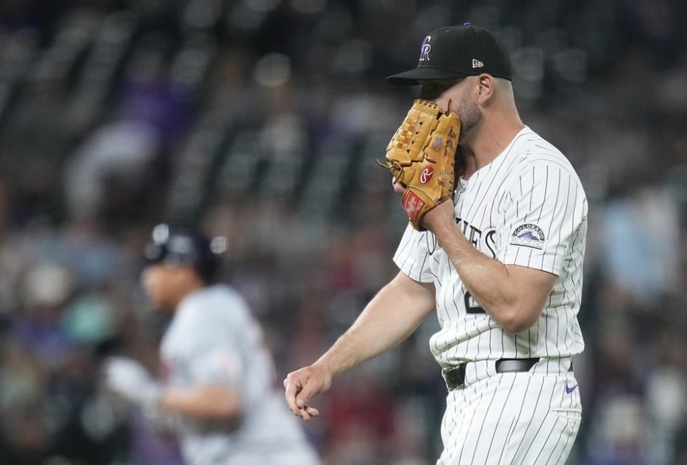 Colorado Rockies relief pitcher Matt Carasiti (29) reacts as Cleveland Guardians' Josh Naylor rounds the bases after hitting a three run home during the eighth inning of a baseball game Tuesday, May 28, 2024, in Denver. (AP Photo/Jack Dempsey)