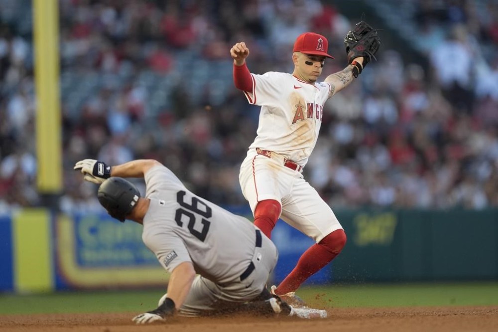 New York Yankees' DJ LeMahieu, left, advances to second next to Los Angeles Angels shortstop Zach Neto on a single by Anthony Volpe during the fourth inning of a baseball game Tuesday, May 28, 2024, in Anaheim, Calif. (AP Photo/Ryan Sun)