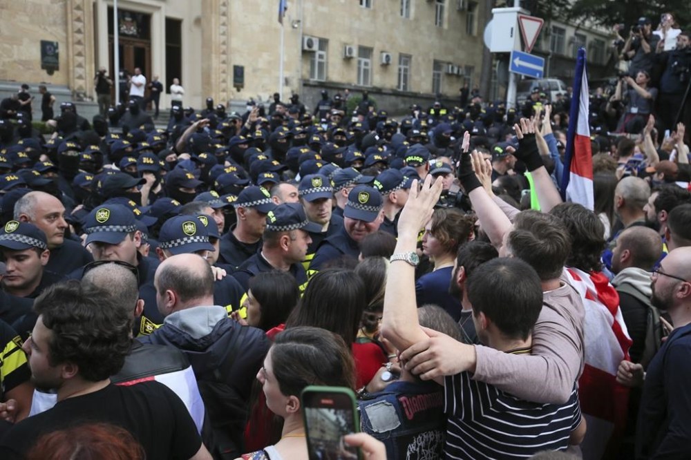 Police block demonstrators during an opposition protest against the foreign influence bill at the Parliamentary building in Tbilisi, Georgia, Tuesday, May 28, 2024. The Georgian parliament has overridden a presidential veto of the