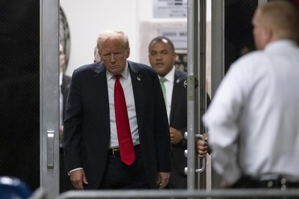 Former President Donald Trump returns from a break as closing arguments continue during his criminal hush money trial in New York, Tuesday, May 28, 2024. (Andrew Kelly/Pool Photo via AP)
