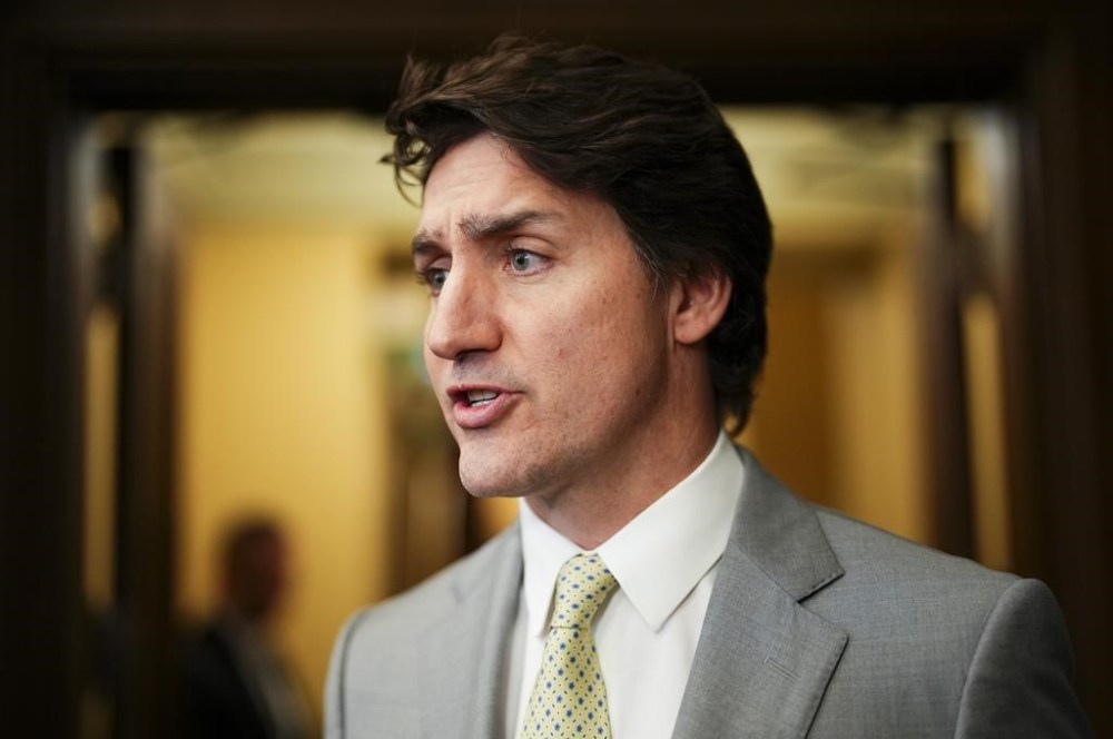 Prime Minister Justin Trudeau speaks to reporters in the foyer of the House of Commons on Parliament Hill in Ottawa on Tuesday, May 28, 2024. Trudeau is set to attend the G7 leaders' summit next month, followed by a Ukraine peace summit in Switzerland. THE CANADIAN PRESS/Sean Kilpatrick