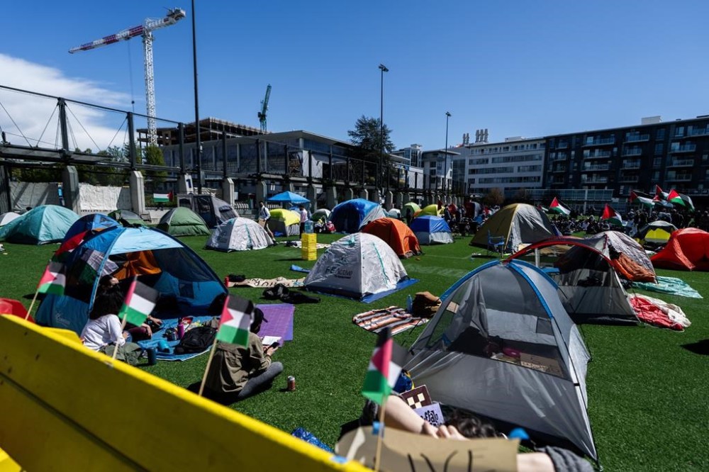 People take over a field with tents during a student encampment for Palestine at the University of British Columbia campus in Vancouver on Monday, April. 29, 2024. THE CANADIAN PRESS/Ethan Cairns