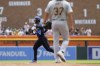 Detroit Tigers' Matt Vierling rounds the bases after a three-run home run as Pittsburgh Pirates starting pitcher Jared Jones (37) walks near the mound during the fifth inning in the first game of a baseball doubleheader, Wednesday, May 29, 2024, in Detroit. (AP Photo/Carlos Osorio)
