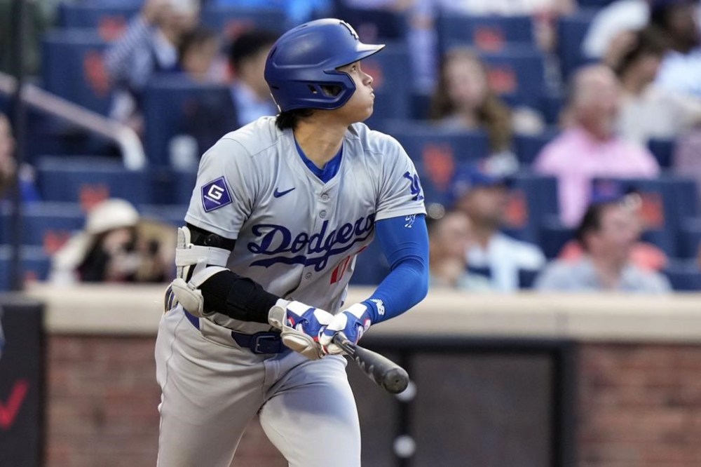 Los Angeles Dodgers' Shohei Ohtani, of Japan, follows through on a two-run home run during the eighth inning of a baseball game against the New York Mets, Wednesday, May 29, 2024, in New York. (AP Photo/Frank Franklin II)