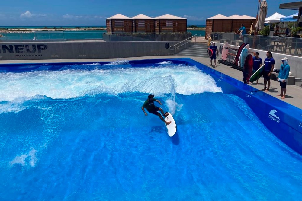 FILE - Ikaika Kaulukukui surfs in a wave pool at Ewa Beach, Hawaii, May 9, 2023. A judge has halted plans for an artificial wave pool until developers can revise an environmental assessment to address concerns raised by Native Hawaiians and others who say the project is unnecessary in the birthplace of surfing and a waste of water. (AP Photo/Jennifer Sinco Kelleher, File)