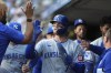 Kansas City Royals' Bobby Witt Jr., center, celebrates in the dugout after scoring on a single by Salvador Perez against the Minnesota Twins during the third inning of a baseball game Wednesday, May 29, 2024, in Minneapolis. (AP Photo/Abbie Parr)