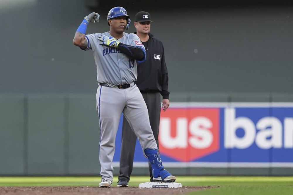 Kansas City Royals' Salvador Perez gestures after hitting an RBI double against the Minnesota Twins during the third inning of a baseball game Wednesday, May 29, 2024, in Minneapolis. (AP Photo/Abbie Parr)