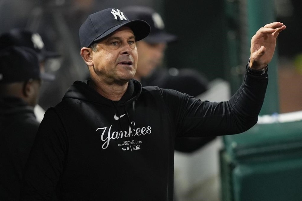 New York Yankees manager Aaron Boone walks in the dugout during the eighth inning of the team's baseball game against the Los Angeles Angels, Tuesday, May 28, 2024, in Anaheim, Calif. (AP Photo/Ryan Sun)