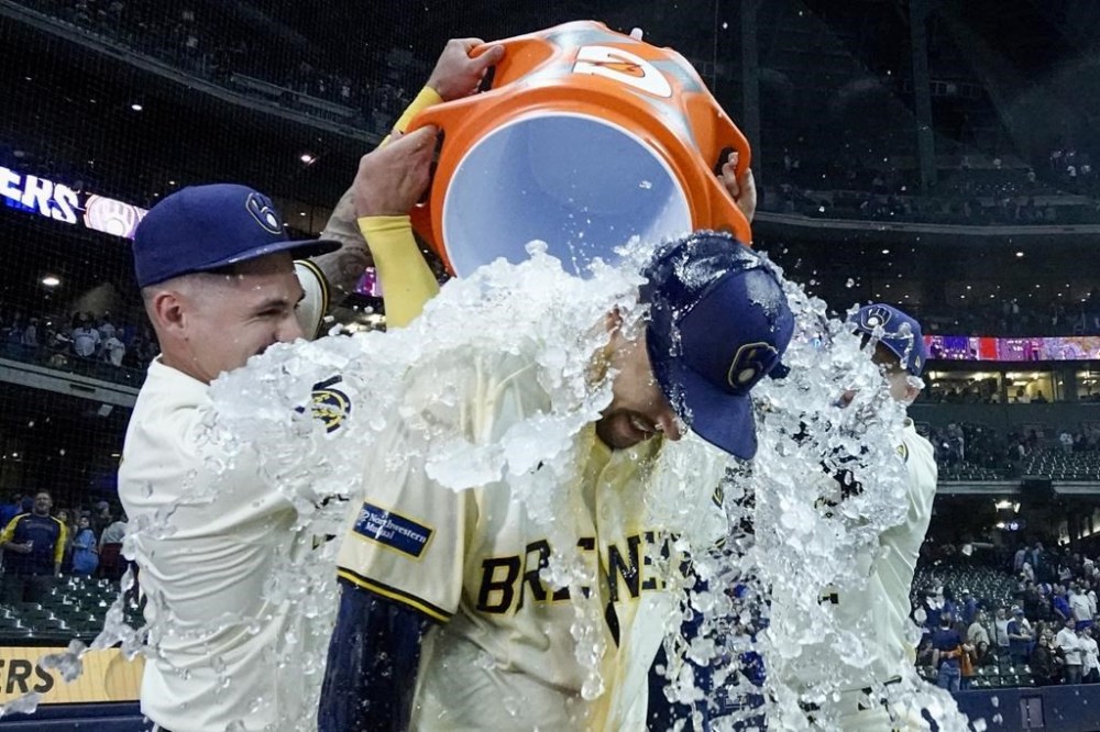 Milwaukee Brewers' Blake Perkins is douced by Brice Turang and Joey Ortiz after a baseball game against the Chicago Cubs Wednesday, May 29, 2024, in Milwaukee. The Brewers won 10-6. (AP Photo/Morry Gash)