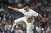 Colorado Rockies relief pitcher Tyler Kinley watches a throw to a Cleveland Guardians batter during the ninth inning of a baseball game Wednesday, May 29, 2024, in Denver. (AP Photo/David Zalubowski)