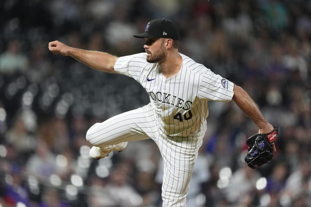 Colorado Rockies relief pitcher Tyler Kinley watches a throw to a Cleveland Guardians batter during the ninth inning of a baseball game Wednesday, May 29, 2024, in Denver. (AP Photo/David Zalubowski)