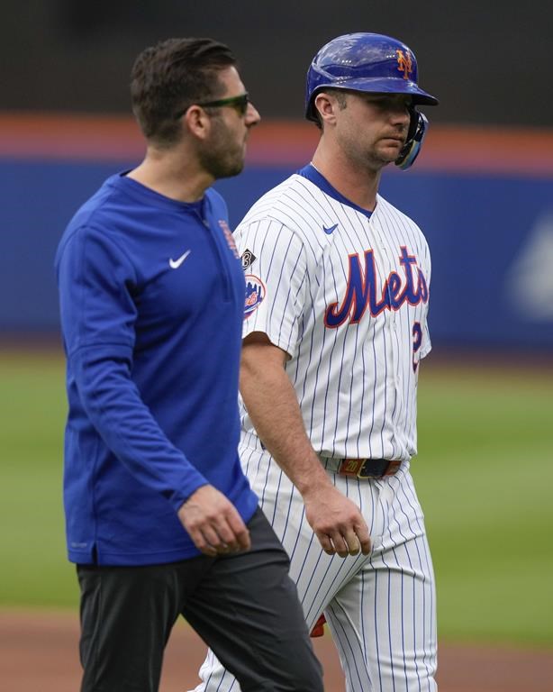 New York Mets' Pete Alonso leaves the field with a trainer after getting injured in the first inning of a baseball game against the Los Angeles Dodgers, Wednesday, May 29, 2024, in New York. (AP Photo/Frank Franklin II)