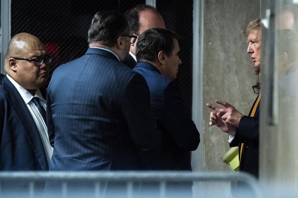 Former President Donald Trump speaks with attorney Todd Blanche and staff outside of the courtroom as jurors begin deliberations for his hush money trial at the Manhattan criminal court, Wednesday, May 29, 2024, in New York. (Jabin Botsford/The Washington Post via AP, Pool)