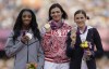 FILE - Russia's Natalya Antyukh, middle, holds the gold medal, United States' Lashinda Demus, left, the silver medal, and Czech Republic's Zuzana Hejnova the bronze medal during a ceremony for the women's 400 hurdles in the Olympic Stadium at the Summer Olympics in London, Aug. 9, 2012. Demus is to be presented in Paris this summer the gold for the race, which was stripped from Antyukh for doping. Demus, now 41 and the mother of four boys, said so much time had passed that she wasn't all that excited when she learned last year that the medal would go to her. (AP Photo/Matt Slocum, FIle)