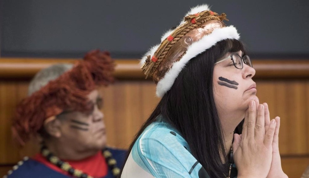 The leadership of a First Nation on British Columbia's central coast says an RCMP officer has been transferred after the community called for his removal from Bella Bella over social media comments he made before joining the Mounties. Chief Marilyn Slett pauses for a moment during a news conference in Vancouver, Wednesday, Oct. 10, 2018. THE CANADIAN PRESS Jonathan Hayward