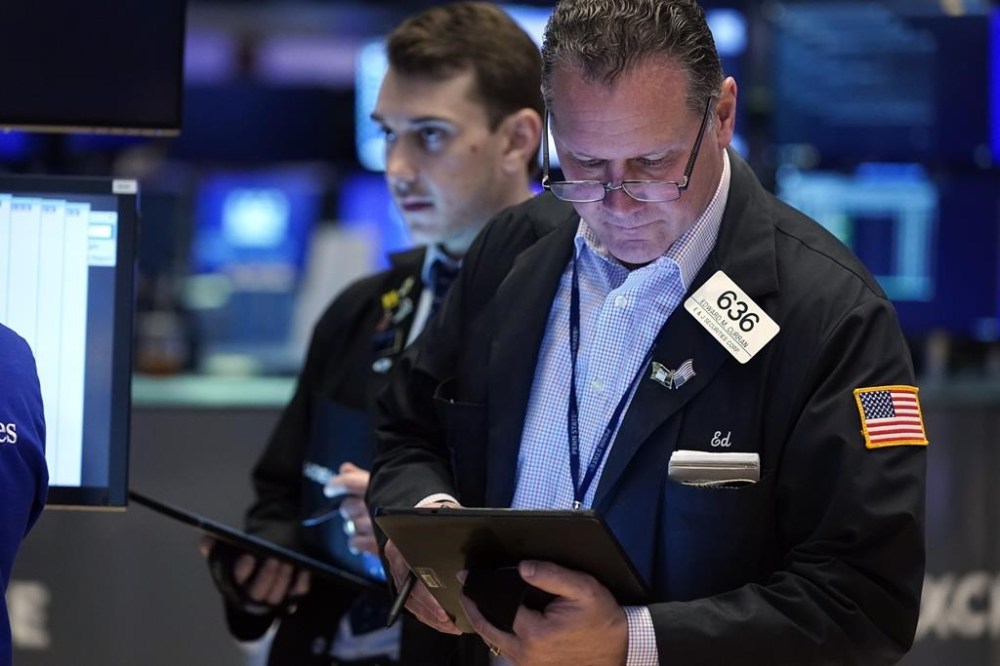 Trader Edward Curran, right, works on the floor of the New York Stock Exchange, Thursday, May 30, 2024. U.S. stocks are drifting Thursday following mixed profit reports from big companies and signals that the economy may be cooling. (AP Photo/Richard Drew)