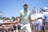 Fans in the gallery reach out to Scottie Scheffler as. he walks to the the tenth tee box during the final round of the Charles Schwab Challenge golf tournament at Colonial Country Club in Fort Worth, Texas, Sunday, May 26, 2024. (AP Photo/LM Otero