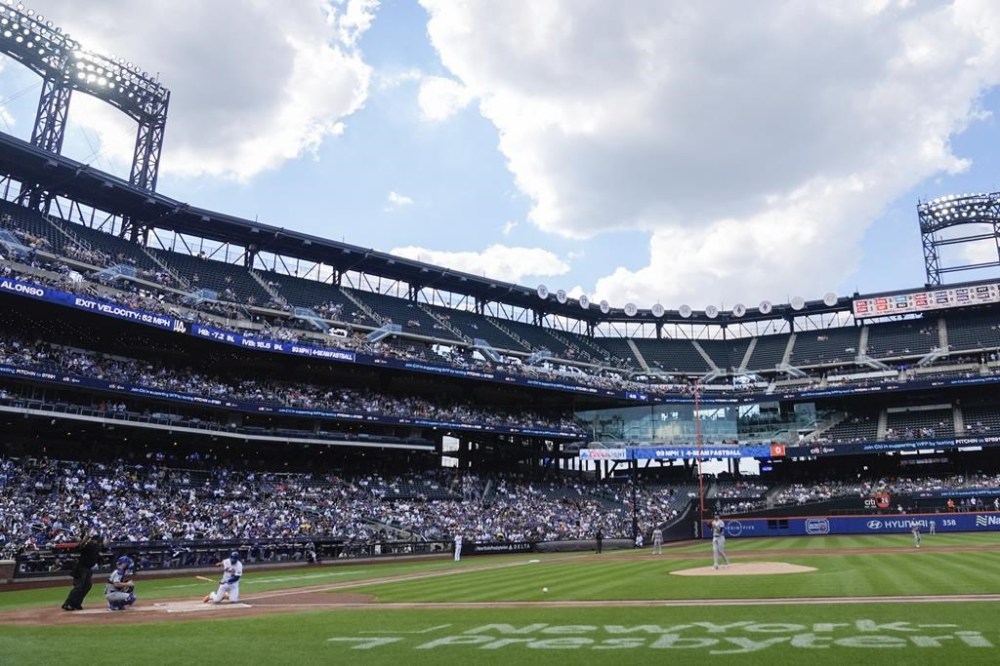 New York Mets' Pete Alonso falls down at home plate after being injured during the first inning of a baseball game against the Los Angeles Dodgers, Wednesday, May 29, 2024, in New York. (AP Photo/Frank Franklin II)