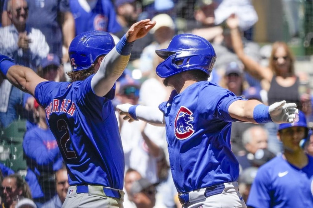 Chicago Cubs' Seiya Suzuki celebrates with Nico Hoerner after hitting a two-run home run during the seventh inning of a baseball game against the Milwaukee Brewers Thursday, May 30, 2024, in Milwaukee. (AP Photo/Morry Gash)