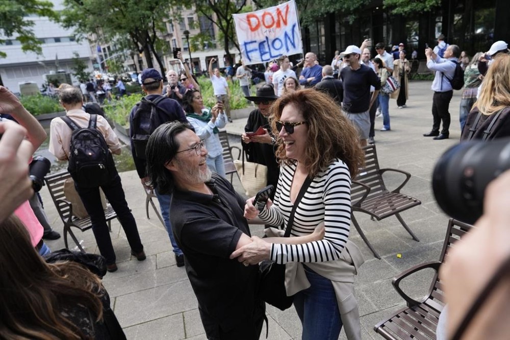 People react to the guilty verdict announced against former President Donald Trump outside Manhattan Criminal Court, Thursday, May 30, 2024, in New York. Donald Trump became the first former president to be convicted of felony crimes as a New York jury found him guilty of 34 felony counts of falsifying business records in a scheme to illegally influence the 2016 election through hush money payments to a porn actor who said the two had sex. (AP Photo/Julia Nikhinson)