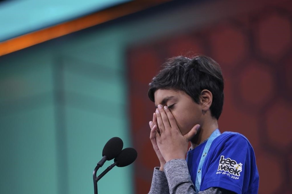 Shrey Parikh, 12, of Rancho Cucamonga, Calif., reacts after spelling a word incorrectly during the finals of the Scripps National Spelling Bee, in Oxon Hill, Md., Thursday, May 30, 2024. (AP Photo/Nathan Howard)
