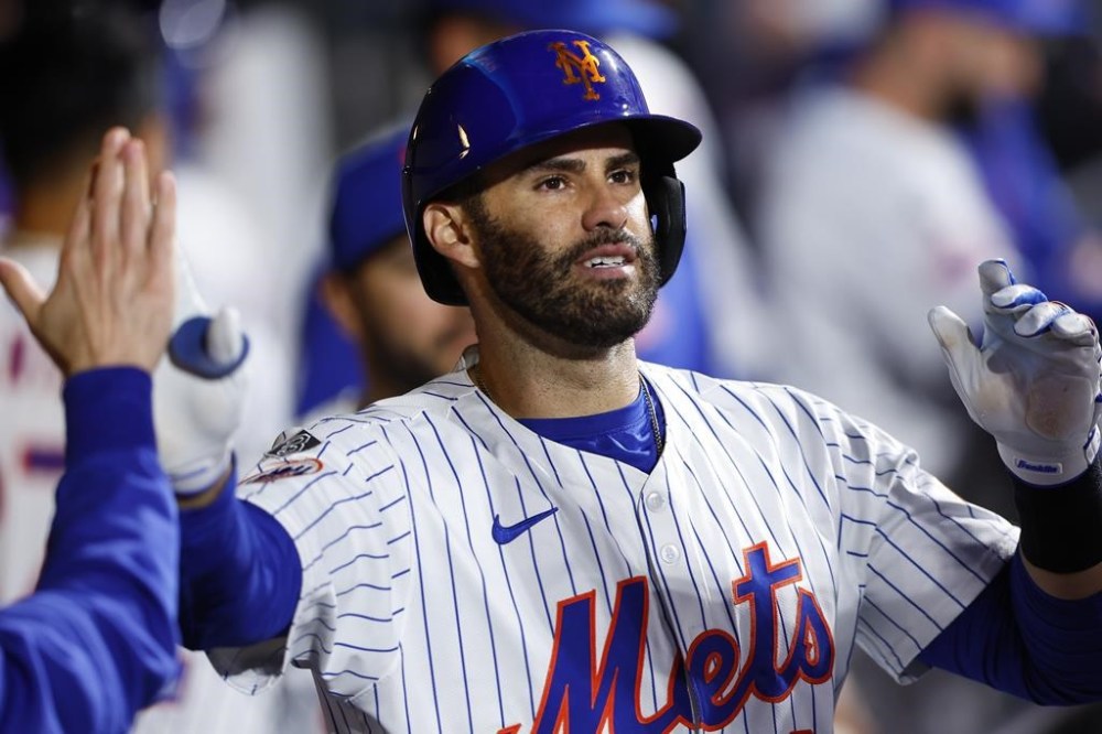 New York Mets' J.D. Martinez celebrates with teammates in the dugout after his home run against the Arizona Diamondbacks during the eighth inning of a baseball game, Thursday, May 30, 2024, in New York. (AP Photo/Noah K. Murray)