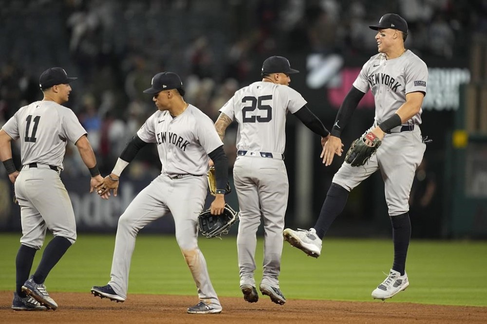New York Yankees' Anthony Volpe, left, Juan Soto, second from left, Gleyber Torres, second from right, and Aaron Judge celebrate after the Yankees defeated the Los Angeles Angels 8-3 in a baseball game Thursday, May 30, 2024, in Anaheim, Calif. (AP Photo/Mark J. Terrill)