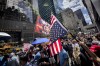 A supporter of former President Donald Trump waves an inverted American flag during a demonstration outside Trump Tower, Friday, May 31, 2024, in New York. A day after a New York jury found Trump guilty of 34 felony charges, the presumptive Republican presidential nominee addressed the conviction and likely attempt to cast his campaign in a new light. (AP Photo/John Minchillo)