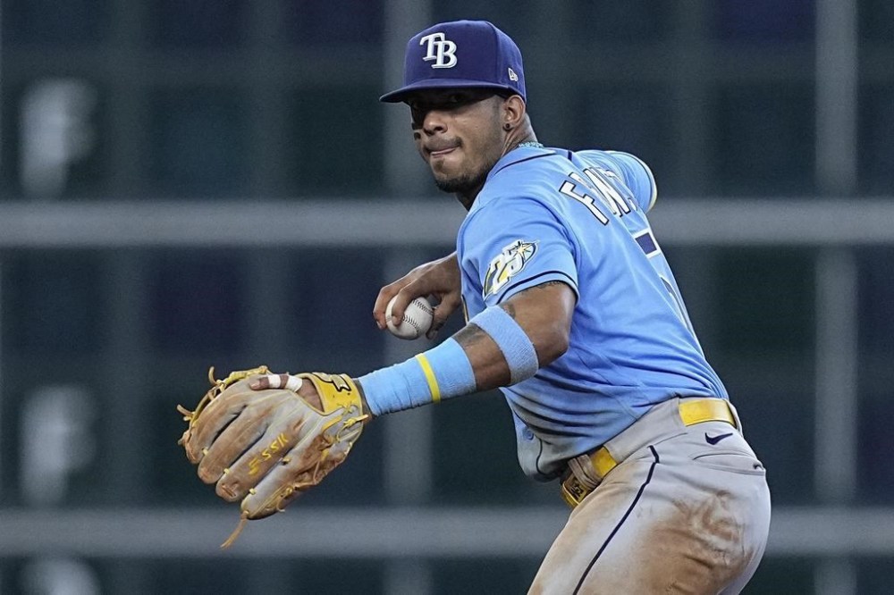 FILE - Tampa Bay Rays shortstop Wander Franco fields a ground ball out from Houston Astros' Mauricio Dubon during the ninth inning of a baseball game, Sunday, July 30, 2023, in Houston. Franco's administrative leave was extended through July 14 by Major League Baseball and the players' association. Tampa Bay's All-Star shortstop has not played since Aug. 12 while MLB continues its investigation into an alleged relationship with a minor. (AP Photo/Kevin M. Cox, File)