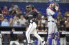 Miami Marlins' Jazz Chisholm Jr., left, scores past Texas Rangers catcher Jonah Heim, right, during the third inning of a baseball game, Friday, May 31, 2024, in Miami. (AP Photo/Lynne Sladky)