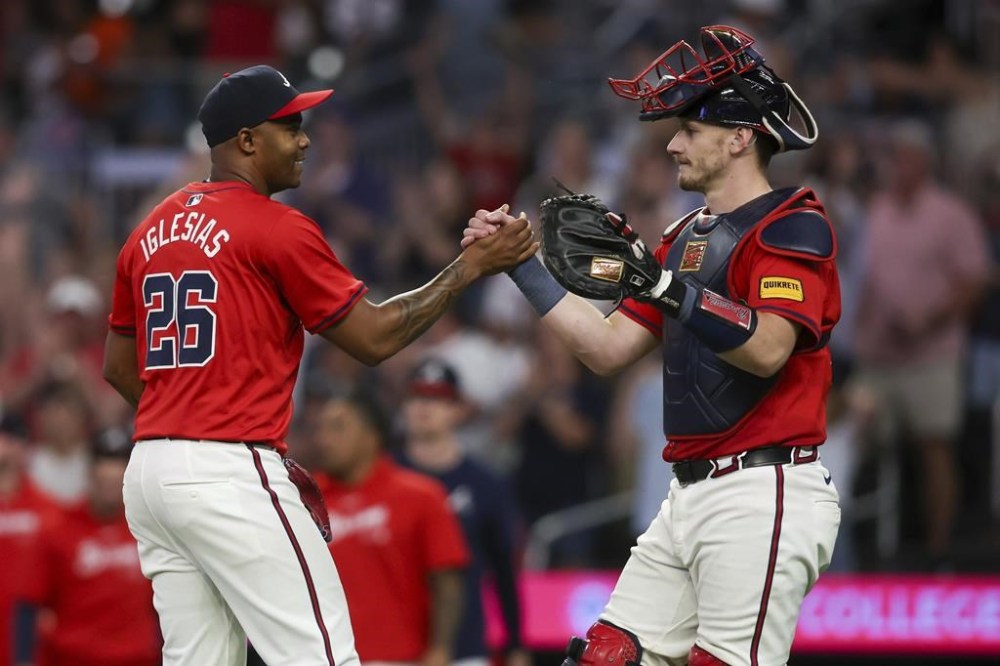 Atlanta Braves relief pitcher Raisel Iglesias (26) and catcher Sean Murphy, right, celebrate after a victory over the Oakland Athletics of a baseball game Friday, May 31, 2024, in Atlanta. (AP Photo/Brett Davis)