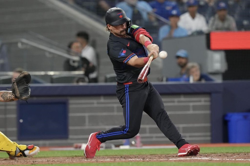Toronto Blue Jays' Davis Schneider hits a game-winning two-run home run against the Pittsburgh Pirates during fourteenth inning interleague MLB baseball action in Toronto, Friday, May 31, 2024. THE CANADIAN PRESS/Chris Young