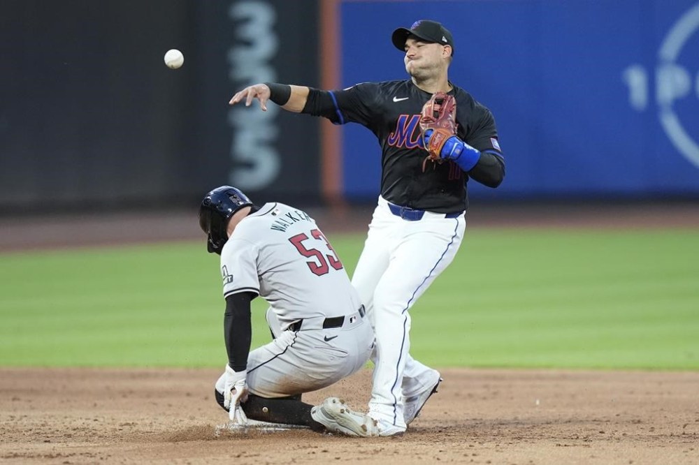 New York Mets' Jose Iglesias, right, throws to first base after forcing out Arizona Diamondbacks' Christian Walker (53) during the third inning of a baseball game, Friday, May 31, 2024, in New York. Lourdes Gurriel Jr. was safe at first base and advanced to second base on a throwing error by Iglesias on the play. (AP Photo/Frank Franklin II)