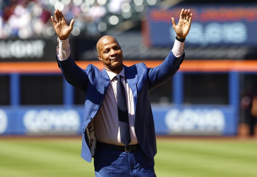 Former New York Mets outfielder Darryl Strawberry acknowledges fans during ceremony to retire his number at Citi Field, Saturday, June 1, 2024, in New York. (AP Photo/Noah K. Murray)