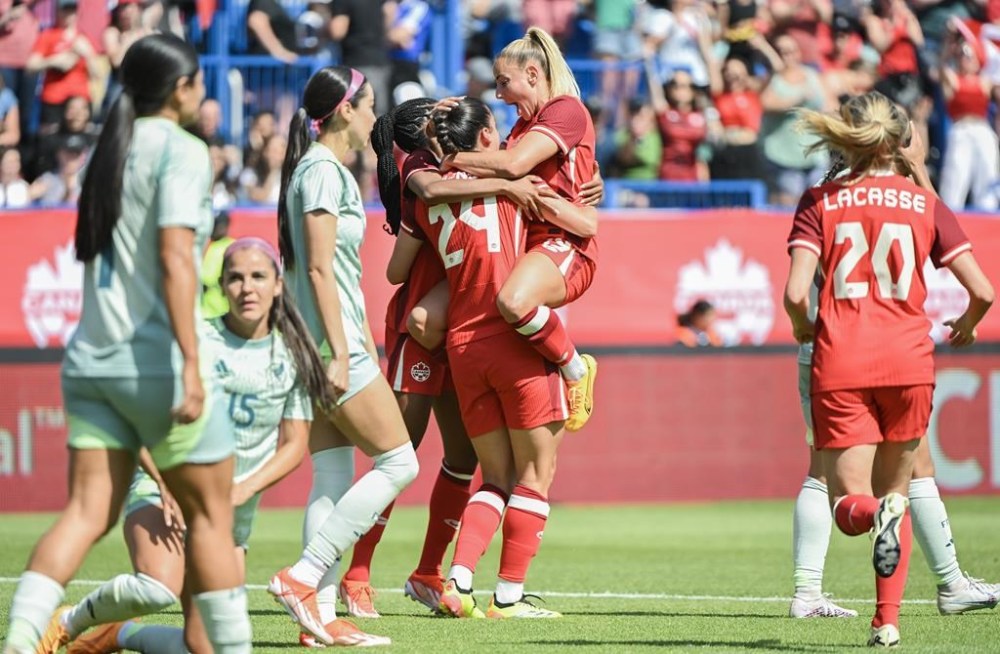 Canada's Adriana Leon (19) celebrates with teammates after scoring against Mexico during second half international soccer action in Montreal, Saturday, June 1, 2024. THE CANADIAN PRESS/Graham Hughes