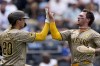 San Diego Padres' Kyle Higashioka (20) and Jackson Merrill celebrate after scoring on a three-run double hit by Ha-Seong Kim during the fourth inning of a baseball game against the Kansas City Royals Saturday, June 1, 2024, in Kansas City, Mo. (AP Photo/Charlie Riedel)