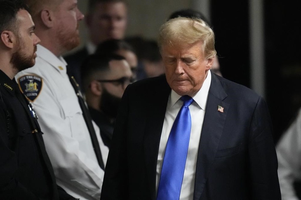 FILE - Former President Donald Trump walks to make comments to media after being found guilty on 34 felony counts of falsifying business records in the first degree at Manhattan Criminal Court, Thursday, May 30, 2024, in New York. As Trump attacked the U.S. criminal justice system following his guilty verdict, analysts say that his allegations could be useful to Russian President Vladimir Putin and other autocrats. (AP Photo/Seth Wenig, Pool, File)