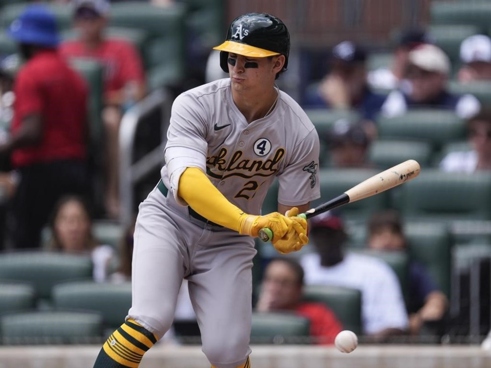 Oakland Athletics' Max Schuemann is hit by a pitch from Atlanta Braves pitcher Charlie Morton in the third inning of a baseball game Sunday, June 2, 2024, in Atlanta. (AP Photo/John Bazemore)
