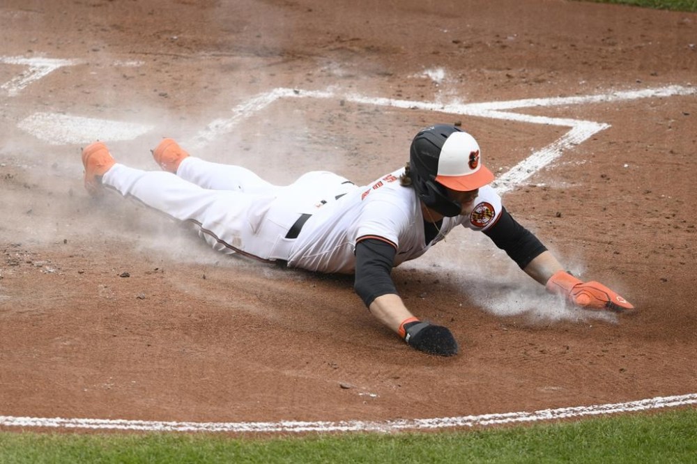 Baltimore Orioles' Gunnar Henderson slides home to score on a single by Anthony Santander during the third inning of a baseball game against the Tampa Bay Rays, Sunday, June 2, 2024, in Baltimore. (AP Photo/Nick Wass)