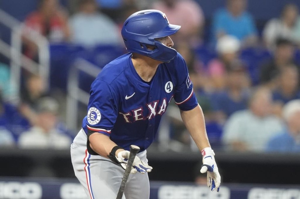 Texas Rangers' Corey Seager watches his single during the first inning of a baseball game against the Miami Marlins, Sunday, June 2, 2024, in Miami. (AP Photo/Lynne Sladky)